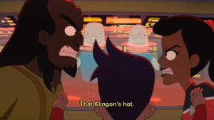 Kimolu and Matt look on as Ma'ah Boilmer and Mariner are arguing. Caption reads: That Klingon's hot
