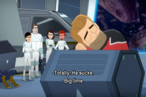 Ransom dozes on some crates as members of Beta and Delta shift look on. Caption reads: Totally. He sucks. Big time.